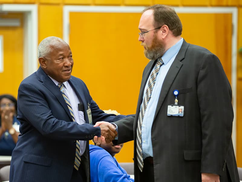 Dr. Jonathan Wilson congratulates Bogan at his retirement reception